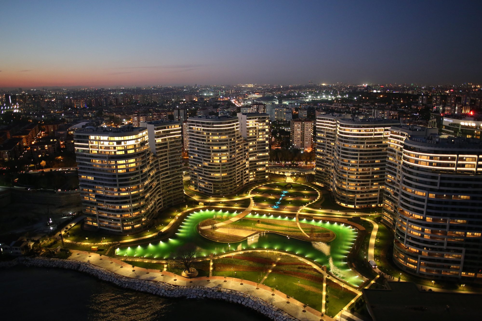 Sea Pearl Ataköy blocks and gardens at night, aerial view